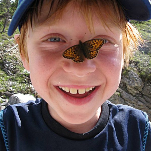 The boy with a butterfly on his nose